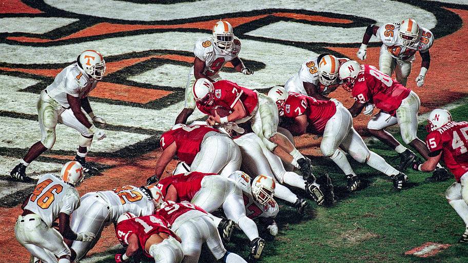 Nebraska quarterback Scott Frost jumps over the line for a touchdown against Tennessee.