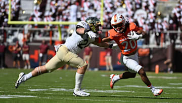 Oct 4, 2025; Blacksburg, Va.; Virginia Tech running back P.J. Prioleau (20) runs with the ball against  Wake Forest linebacker Dylan Hazen (24).