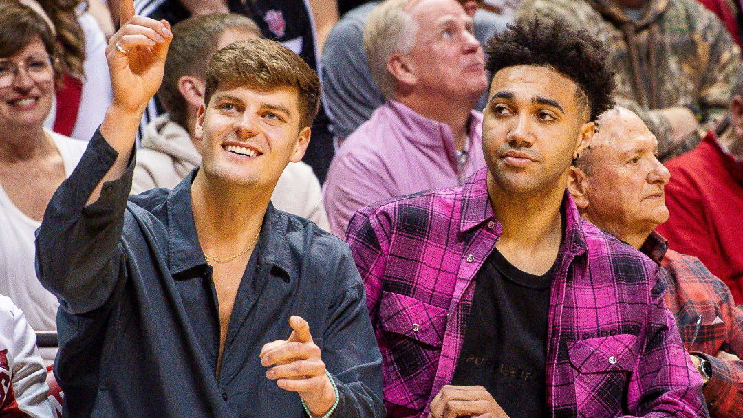 Former Hoosiers Miller Kopp and Trayce Jackson-Davis sit courtside during the second half of the