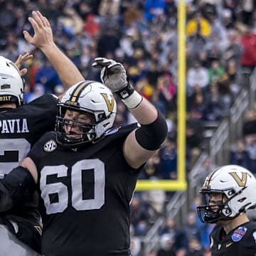 Dec 27, 2024; Birmingham, AL, USA;  Vanderbilt Commodores quarterback Diego Pavia (2) celebrates his touchdown run against the Georgia Tech Yellow Jackets with Vanderbilt Commodores offensive lineman Duncan MacDonald (60) during the first half of the 2024 Birmingham Bowl at Protective Stadium. Mandatory Credit: Vasha Hunt-Imagn Images