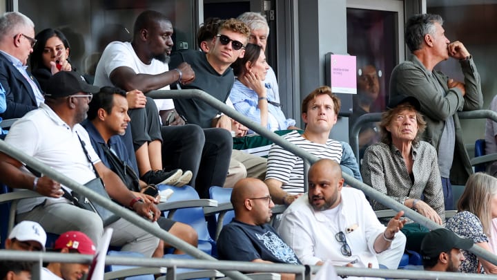 Leon Marchand and Mick Jagger watch Olympic track and field together in Paris on Aug. 8, 2024.