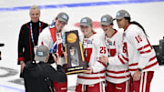 Wisconsin captains, from left, Caroline Harvey and Casey O'Brien and assistant captains Lacey Eden and Laila Edwards pose for photos with the national championship trophy after Wisconsin's 4-3 victory over Ohio State in the NCAA women's hockey Frozen Four title game Sunday, March 23, 2025, at Ridder Arena in Minneapolis, Minnesota.