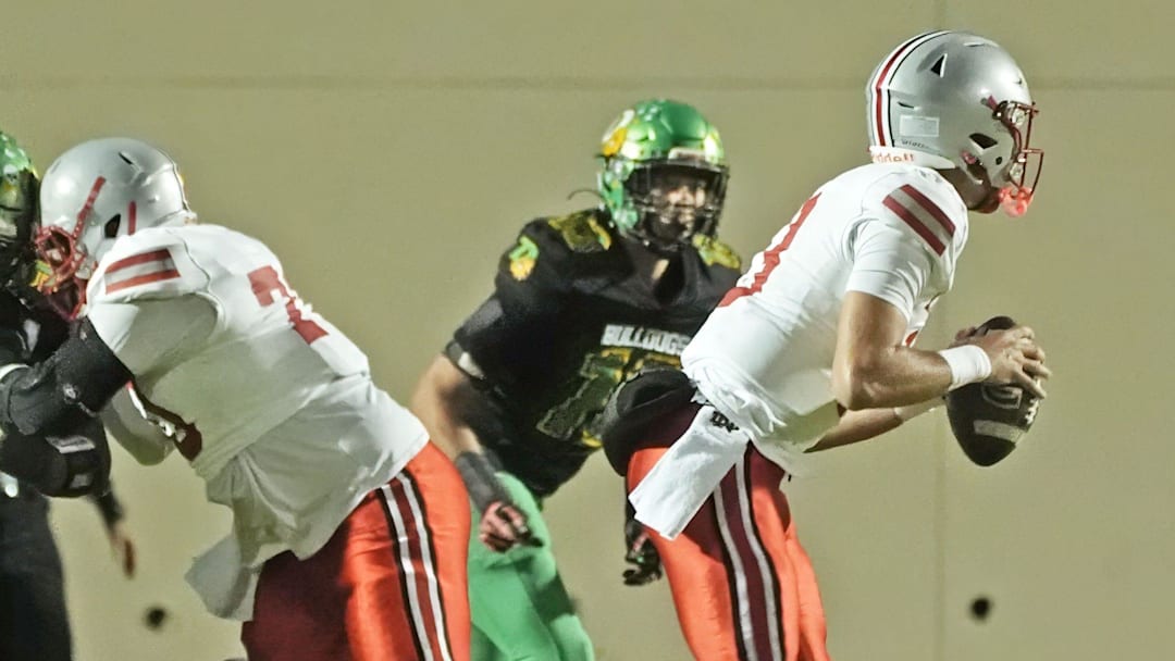 Lake Mary's Noah Grubbs (13) looks for an open player downfield against DeLand in the Region 1-7A finals on Nov. 28, 2025. Lake Mary won 40-31, advancing to the state semifinals.