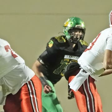 Lake Mary's Noah Grubbs (13) looks for an open player downfield against DeLand in the Region 1-7A finals on Nov. 28, 2025. Lake Mary won 40-31, advancing to the state semifinals.