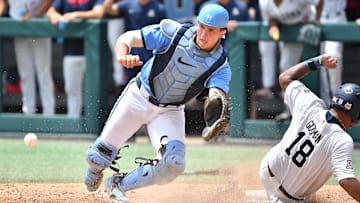Arizona's Adonys Guzman (18) slides into home plate to score beating the throw to North Carolina catcher Luke Stevenson (44) . The North Carolina Tar Heels and the Arizona Wildcats met in game two of the NCAA Division 1 Super Regionals in Chapel Hill, N.C. on June 7, 2025.