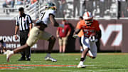 Oct 4, 2025; Blacksburg, Virginia, USA;  Virginia Tech Hokies running back Marcellous Hawkins (27) runs with the ball against Wake Forest Demon Deacons linebacker Aiden Hall (21) during the third quarter at Lane Stadium. Mandatory Credit: Brian Bishop-Imagn Images