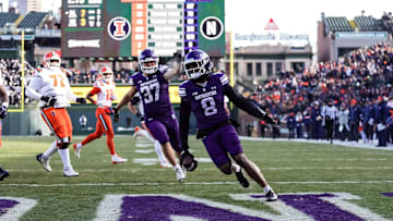 Northwestern Wildcats cornerback Devin Turner returns an interception for a touchdown against the Illinois Fighting Illini on November 30, 2024.