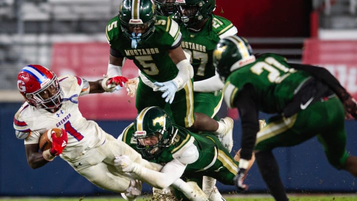 West Jones Mustangs' linebacker Brayden Nance (40) tackles Grenada Chargers' cornerback Jekerious Williams (1) during the MHSAA class 6A football state title game at Vaught-Hemingway Stadium in Oxford, Miss., on Friday, Dec. 1, 2023.