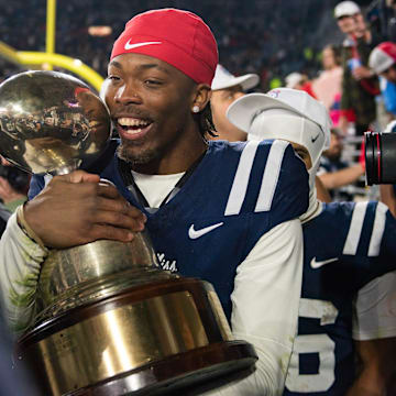 Mississippi's cornerback Isaiah Hamilton (3) holds the Golden Egg trophy after they won the Egg Bowl game against Mississippi State at Vaught-Hemingway Stadium on Friday, Nov. 29, 2024.