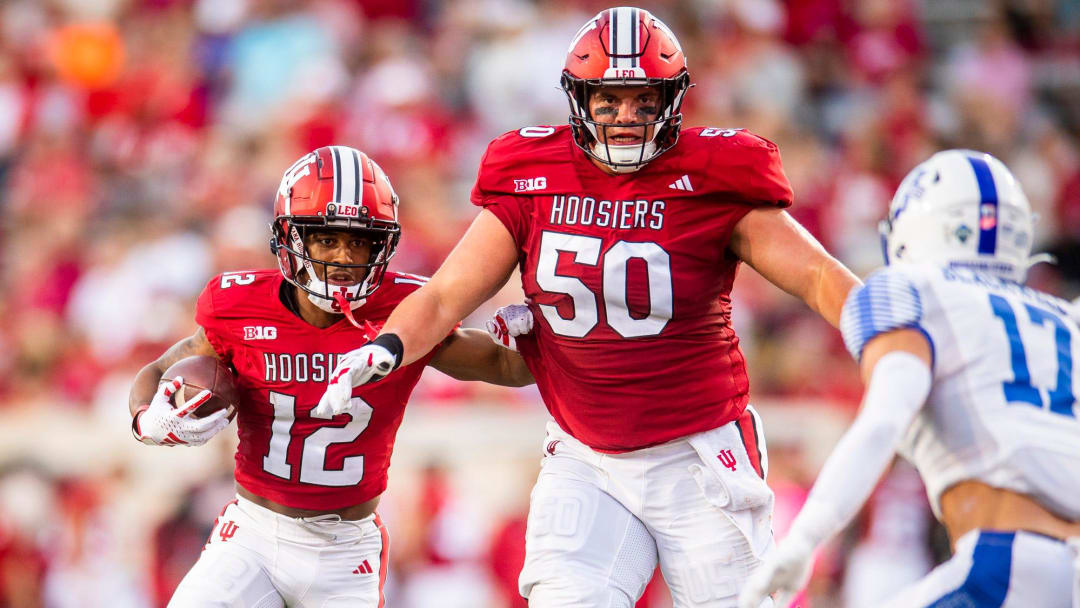 Indiana's Jaylin Lucas (12) runs behind Zach Carpenter (50) during the first half of the Indiana versus Indiana State football game at Memorial Stadium on Friday, Sept. 8, 2023.