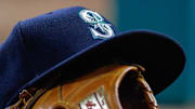 Jun 4, 2016; Arlington, TX, USA; A Seattle Mariners hat sits on top a mitt during a game against the Texas Rangers at Globe Life Park in Arlington. Rangers won 10-4. Mandatory Credit: Ray Carlin-Imagn Images