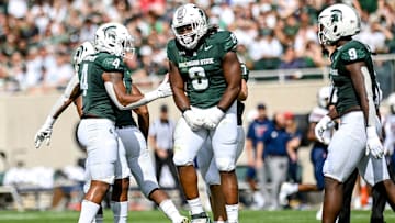 Michigan State's Simeon Barrow Jr., center, celebrates his sack against Richmond during the first quarter on Saturday, Sept. 9, 2023, at Spartan Stadium in East Lansing.