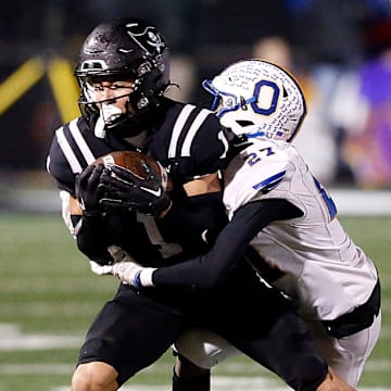 Ontario High School's Tre Fowler (27) tackles Perkins High School's Braylon Collier (1) during their OHSAA Division IV Region 14 championship high school football game Friday, Nov. 22, 2024 at Tiffin Frost Kalnow Stadium. TOM E. PUSKAR/MANSFIELD NEWS JOURNAL