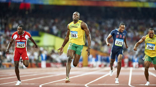 Usain Bolt crosses the finish line at the Olympics. 