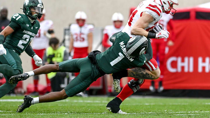 Michigan State's Jaden Mangham, below, tackles Nebraska's Alex Bullock during the first quarter on