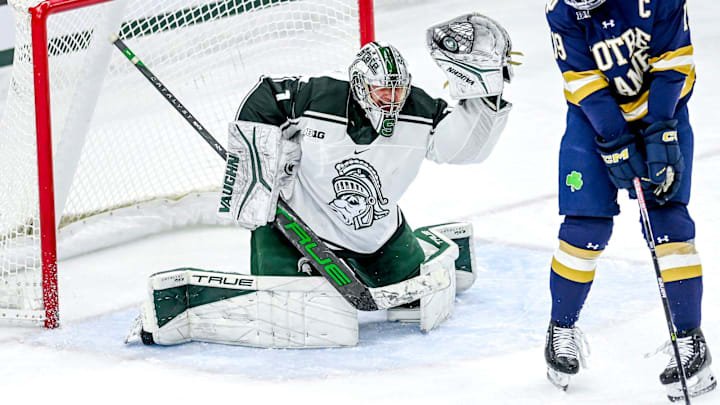 Michigan State's Trey Augustine saves a Notre Dame goal attempt during the first period on Friday, Dec. 8, 2023, at Munn Arena in East Lansing.