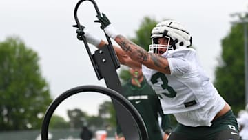 MSU's Isaac Smith works a sled, Tuesday, July 29, 2025, during the first day of football practice at the Skandalaris Football Center.