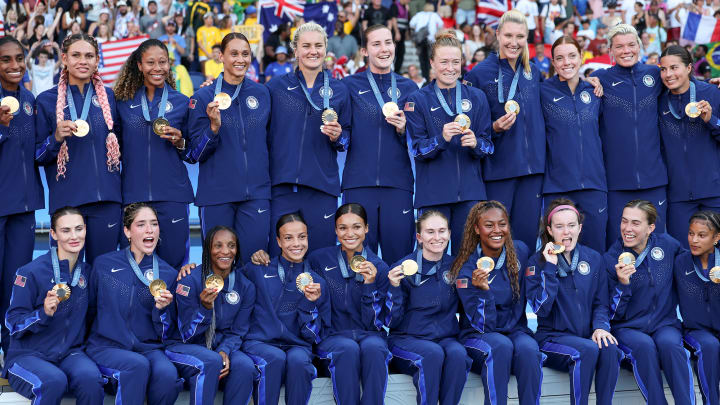 The USWNT poses with their gold medals after defeating Brazil 1–0 in the gold-medal game in Paris.