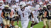 Sep 20, 2025; Blacksburg, Virginia, USA;  Virginia Tech Hokies quarterback Kyron Drones (1) runs the ball for a touchdown during the fourth quarter against the the Wofford Terriers at Lane Stadium. Mandatory Credit: Brian Bishop-Imagn Images
