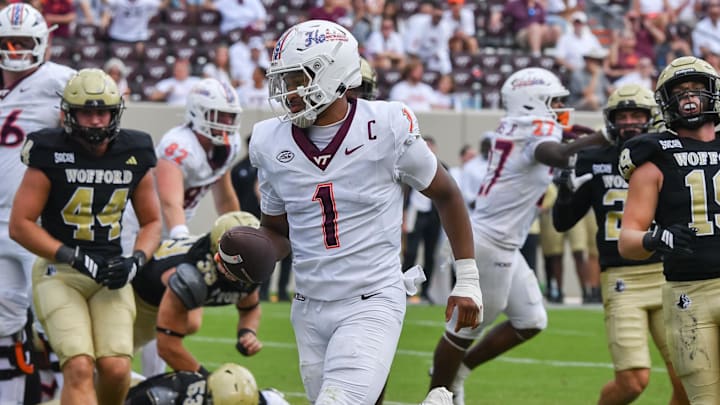 Sep 20, 2025; Blacksburg, Virginia, USA; Virginia Tech Hokies quarterback Kyron Drones (1) runs the ball for a touchdown during the fourth quarter against the the Wofford Terriers at Lane Stadium. Mandatory Credit: Brian Bishop-Imagn Images Sep 20, 2025; Blacksburg, Virginia, USA; Virginia Tech Hokies quarterback Kyron Drones (1) runs the ball for a touchdown during the fourth quarter against the the Wofford Terriers at Lane Stadium. Mandatory Credit: Brian Bishop-Imagn Images