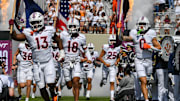 Sep 20, 2025; Blacksburg, Va.; Virginia Tech defensive lineman Kemari Copeland (13), quarterback A.J. Brand (18) and wide receiver Ayden Greene (0) run onto the field.