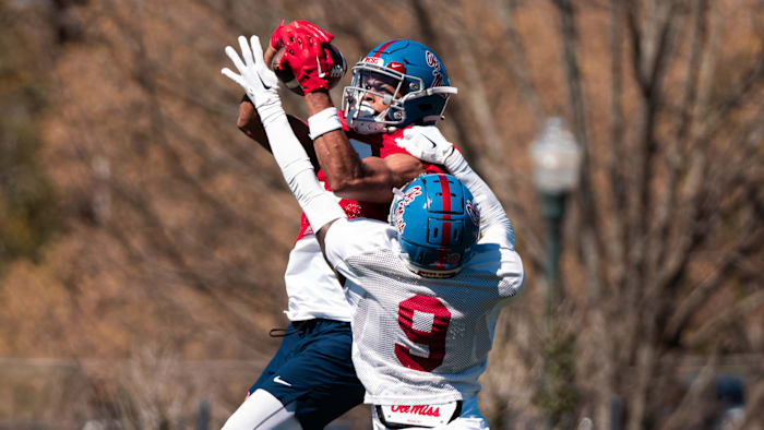 Ole Miss Rebels WR Tre Harris (red jersey) and cornerback Trey Amos
