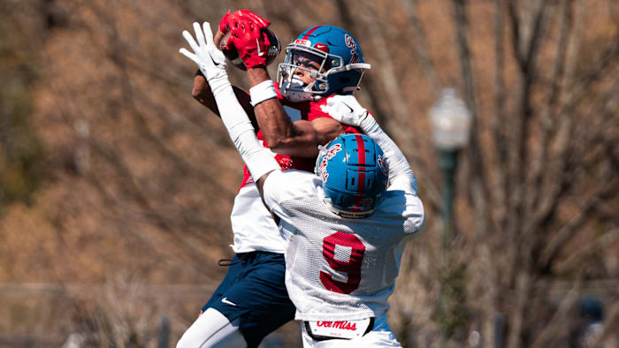 Ole Miss Rebels WR Tre Harris (red jersey) and cornerback Trey Amos