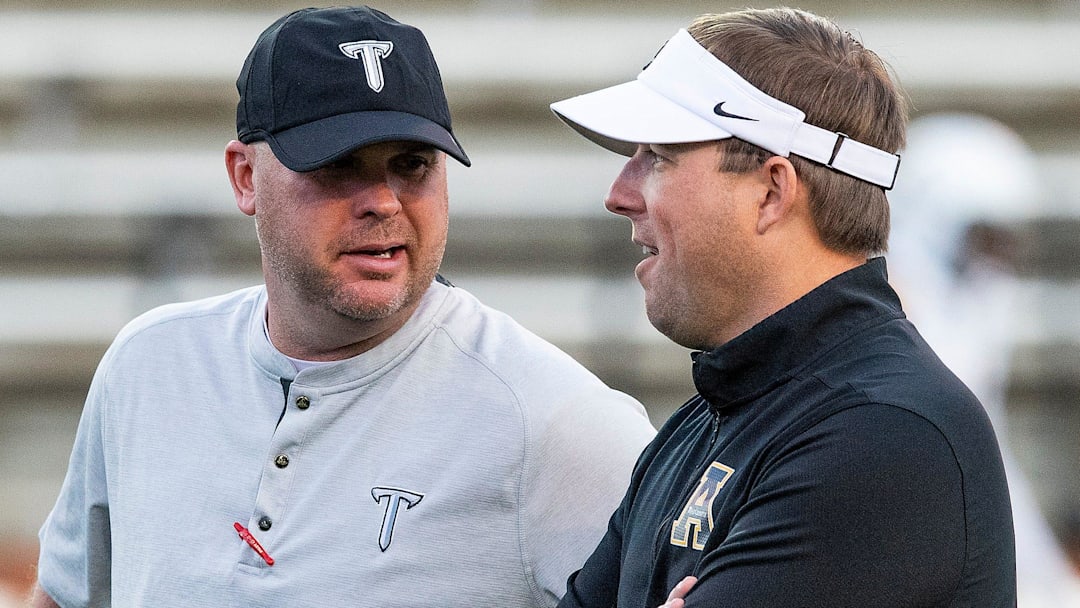 Troy head coach Chip Lindsey and Appalachian State head coach Eliah Drinkwitz chat before their game on the Troy campus in Troy, Ala., on Friday, November 29, 2019.

T01