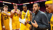Frank Mitchell (00) wearing a sling for his right arm during a team huddle in Minnesota's exhibition win over Hamline. 