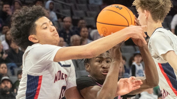 Lincoln's Donez Lindsey, right, fights for a loose ball with Modesto Christian's Myles Jones in the Sac-Joaquin Section boys basketball championship game at Golden One Center in Sacramento on Feb. 21. 2024. Modesto Christian won 68-63.