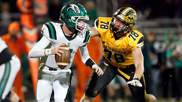 Colonel Crawford High School's Payne DeGray (78) pressures Reedsville Eastern High School's quarterback Braxton Yonker (4)