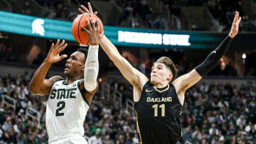 Michigan State's Tyson Walker, left, shoots as Oakland's Blake Lampman defends during the first half on Monday, Dec. 18, 2023, at the Breslin Center in East Lansing.