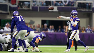 Vikings left tackle Christian Darrisaw (71) blocking for quarterback J.J. McCarthy (9). 