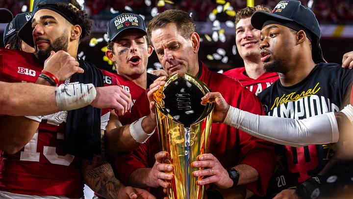 Indiana Head Coach Curt Cignetti prepares to lift the trophy on the podium after the College Football Playoff National Championship college football game at Hard Rock Stadium in Miami Gardens on Monday, Jan. 19, 2026.