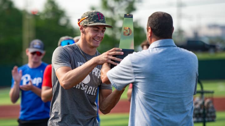 Kevin Griffin hands his son Konnor Griffin a trophy for Gatorade National Baseball Player of the Year at Jackson Prep in Flowood, Miss., on Thursday, June 6, 2024.