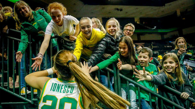 Young fans high five Oregon's Sabrina Ionescu as she leaves the court after leading the Ducks to a 76-64 win.