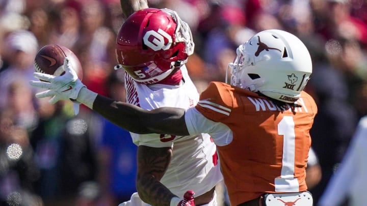 Texas Longhorns wide receiver Xavier Worthy (1) drops the ball against Oklahoma Sooners defensive back Woodi Washington (5) defending on the play. .