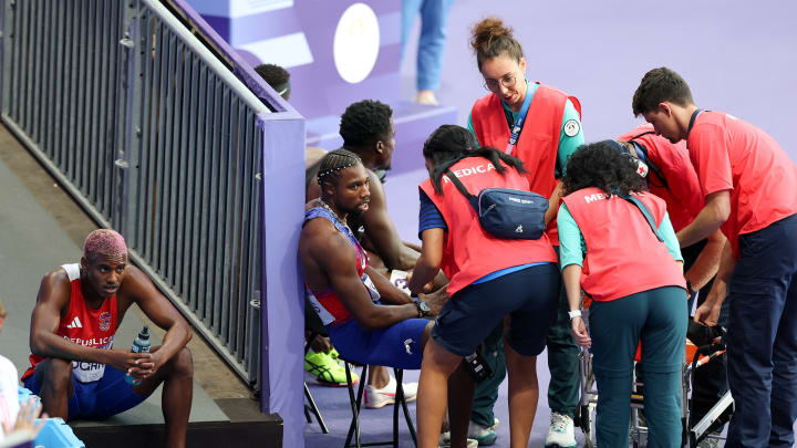 Lyles receives medical attention after the 200-meter final.