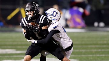 Ontario High School's Tre Fowler (27) tackles Perkins High School's Braylon Collier (1) during their OHSAA Division IV Region 14 championship high school football game Friday, Nov. 22, 2024 at Tiffin Frost Kalnow Stadium. TOM E. PUSKAR/MANSFIELD NEWS JOURNAL