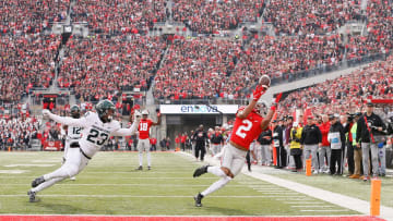 Ohio State WR Chris Olave (2) hauls in a pass behind Michigan State Spartans safety Darius Snow (23) during the second quarter.