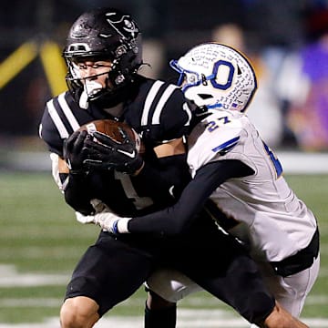 Ontario High School's Tre Fowler (27) tackles Perkins High School's Braylon Collier (1) during their OHSAA Division IV Region 14 championship high school football game Friday, Nov. 22, 2024 at Tiffin Frost Kalnow Stadium. TOM E. PUSKAR/MANSFIELD NEWS JOURNAL