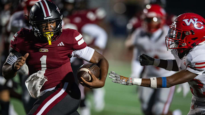 Germantown Mavericks' quarterback King White (1) runs the ball during the game against the Warren Central Vikings in Madison, Miss., on Friday, Sept. 13, 2024.