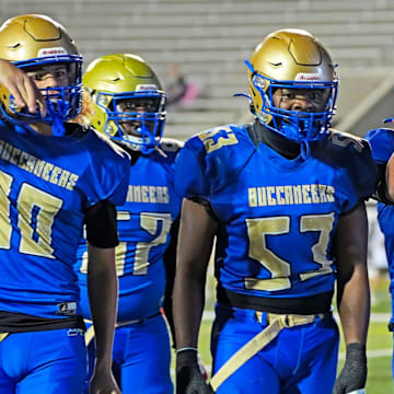 Mainland football players celebrate Braylyn Simmons' (6) touchdown during their Class 5A, Region 1 semifinal game against Lynn Haven Mosley on Friday, Nov. 21, 2025. The Buccaneers won 36-31.
