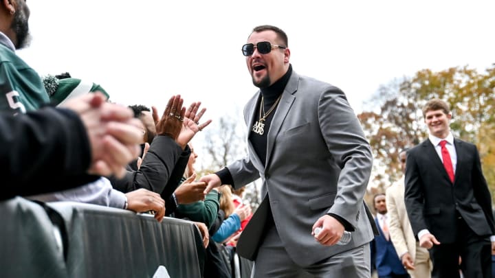 Michigan State's Nick Samac greets fans as the Spartans walk into Spartan Stadium before the football game against Nebraska on Saturday, Nov. 4, 2023, in East Lansing.