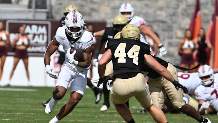 Sep 20, 2025; Blacksburg, Va.; Virginia Tech running back Jeremiah Coney (4) runs the ball against Wofford.