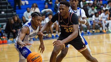 Murrah Mustangs' power forward Jayden Johnson (21) and Germantown Mavericks' Sam Funches (32) reach for the ball during the game in Jackson, Miss., on Friday, Jan. 31, 2025.