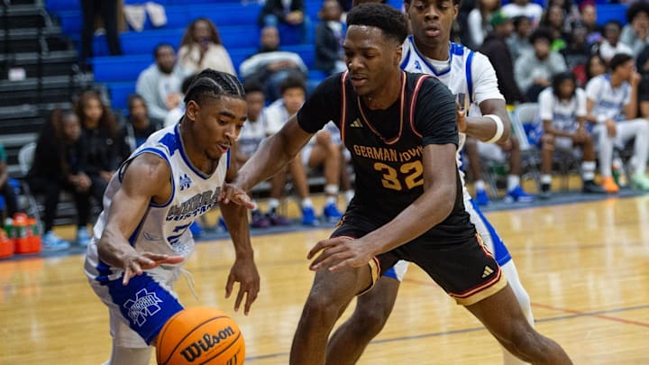Murrah Mustangs' power forward Jayden Johnson (21) and Germantown Mavericks' Sam Funches (32) reach for the ball during the game in Jackson, Miss., on Friday, Jan. 31, 2025.