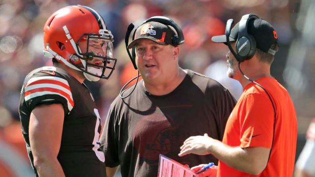 Quarterback speaks with head coach and offensive coordinator.