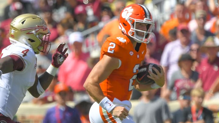 Sep 23, 2023; Clemson, South Carolina, USA; Clemson Tigers quarterback Cade Klubnik (2) runs against Florida State Seminoles linebacker Karen DeLoach (4) during the second quarter at Memorial Stadium. Mandatory Credit: Ken Ruinard-Imagn Images