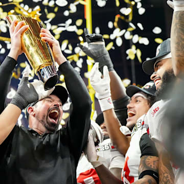 Ohio State's Ryan Day (center) joins Urban Meyer, Jim Tressel, Woody Hayes and Paul Brown in the select fraternity of national champion coaches at Ohio State.